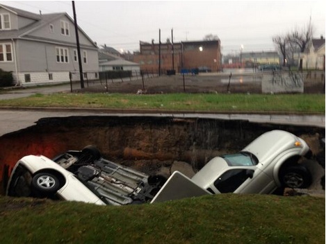 A sinkhole opened up in a neighborhood which cars have fallen into
