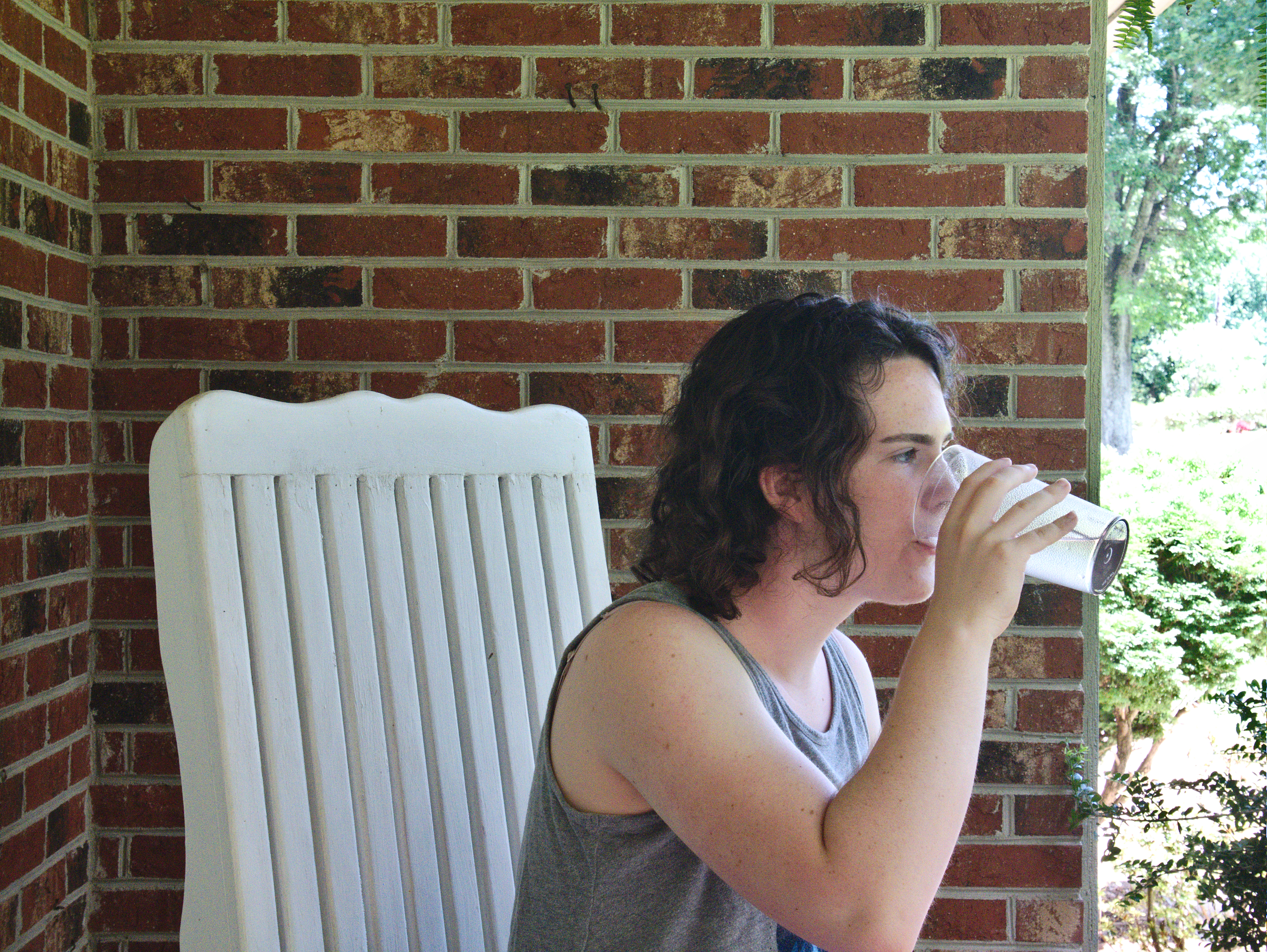 A girl drinks a glass of water