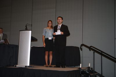 Shuai Lou accepts the first place award in the poster competition at the WaterJAM conference in Norfolk, VA