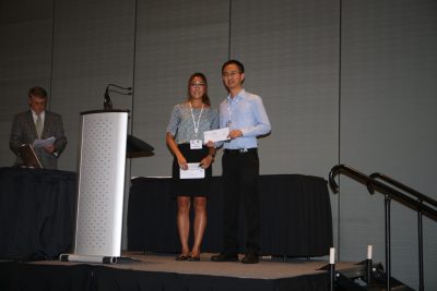 Shiqiang Zuo accepts the first place award in the poster competition at the WaterJAM conference in Norfolk, VA