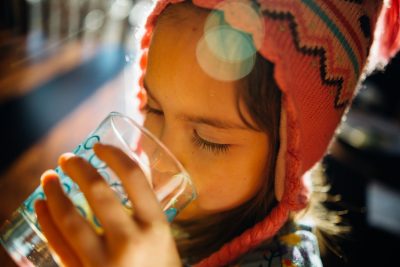 A child drinks water from a glass