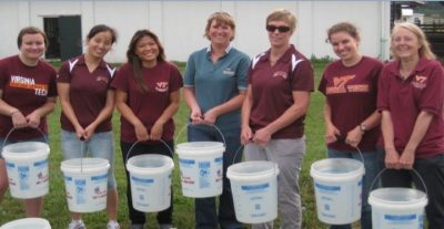 A research team holds buckets