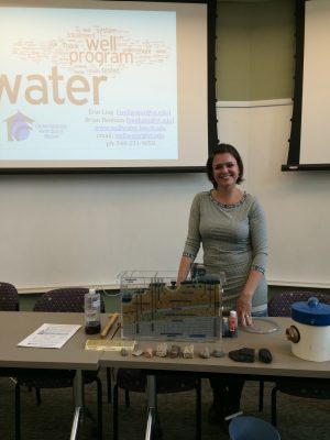 Erin Ling presents a demonstration of groundwater infiltration using a small model