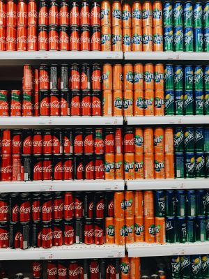 Shelves filled with various cans of soda