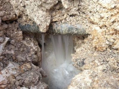 A cracked pvc pipe leaks water