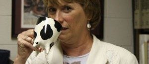 Dr. Susan Duncan drinks from a cow themed coffee cup