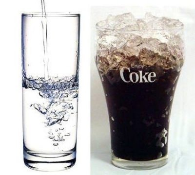 A glass of water beside a glass of coke